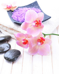 Still life with beautiful blooming orchid flower, towel and