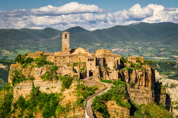 Ancient city on hill in Tuscany on a mountains background.