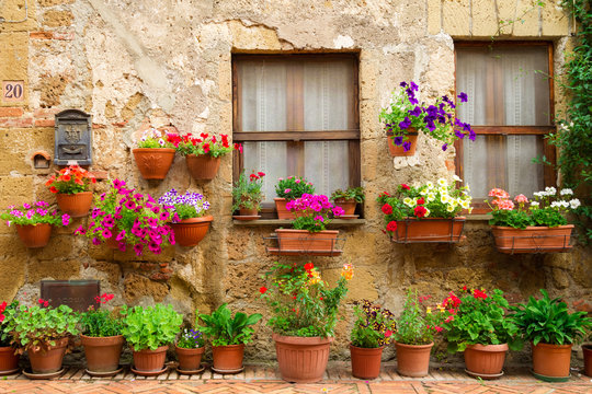 Fototapeta Beautiful street decorated with flowers in Italy