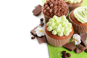 Tasty cupcakes with butter cream,on color napkin, isolated