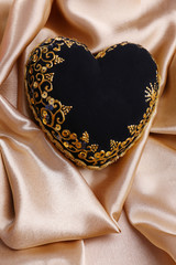 Decorative black heart, on color fabric