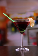 Glass of tasty cocktail on bright background