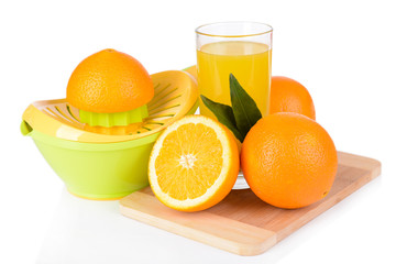 Citrus press and oranges isolated on white