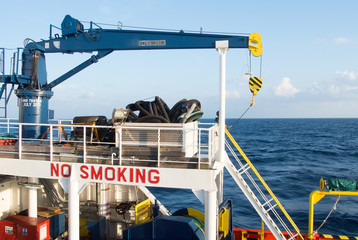 crane in supply boat use for lifting cargo