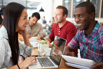 Customers In Busy Coffee Shop