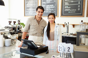 Male And Female Staff In Coffee Shop