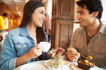 Couple Meeting In Busy Café Restaurant