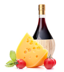 Red wine bottle, cheese and tomato still life