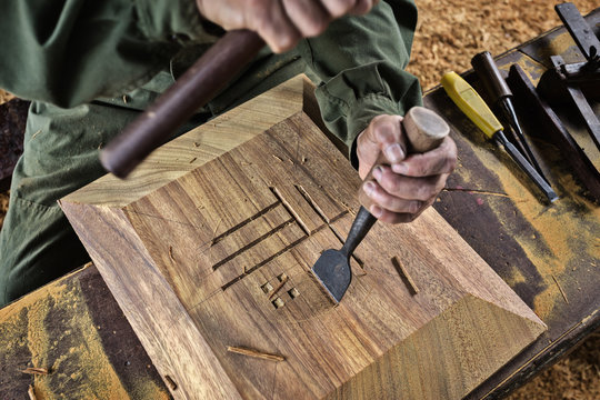 Carpenter working with chisel