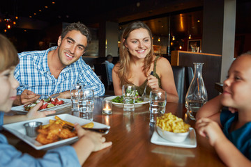 Family Enjoying Meal In Restaurant
