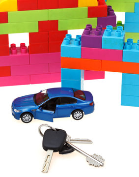 keys, model car, plastic block house