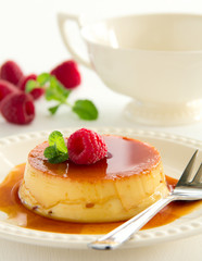 Creme caramel with raspberries.