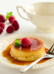 Creme caramel with raspberries.