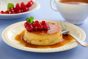 Creme caramel with raspberries.