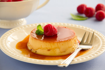 Creme caramel with raspberries.
