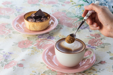 woman pouring sugar