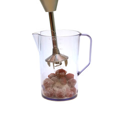 Electric blender and strawberries with sugar inside jug isolated