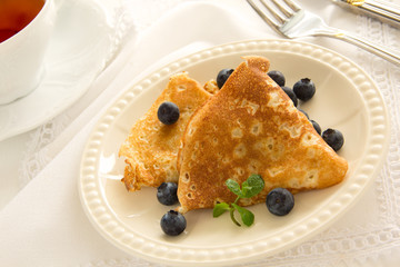 Delicious pancakes with berries and honey