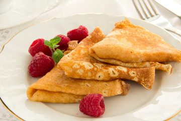 Delicious pancakes with berries and honey