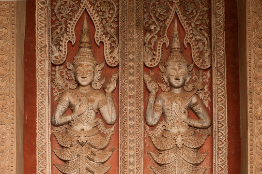 Ancient Laos art wood carving in Laos temple.