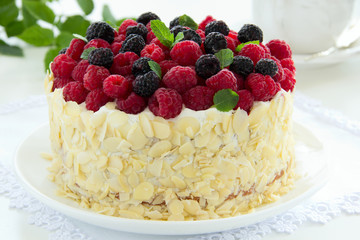 Sponge cake with cream and raspberries.