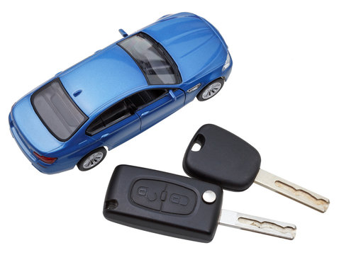 above view of two vehicle keys and model car