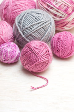 balls of pink and gray yarn