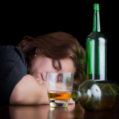 Dark dramatic image of a drunk and tired woman