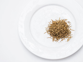 Rosemary  on the white plate.