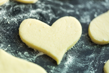 Raw biscuits on the black pan