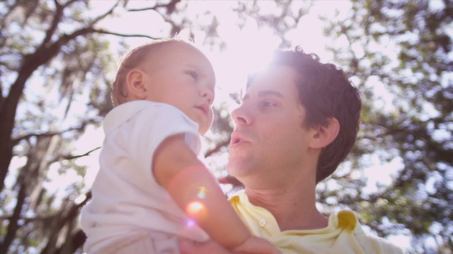 Close up Young Father Holding Toddler Son Outdoors