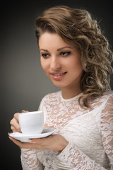 Portrait of young  girl brown hair drinking coffee