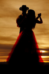 Silhouette couple dancing hands out