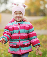 Happy kid in autumn park