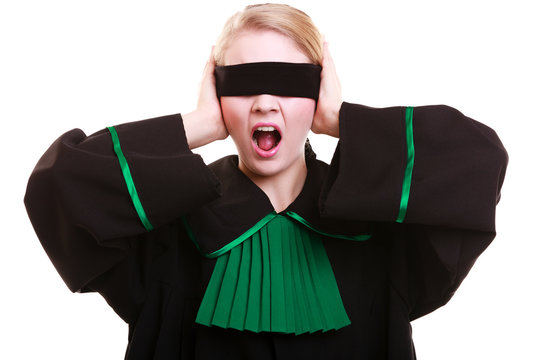 Lawyer attorney in polish gown covering eyes with blindfold