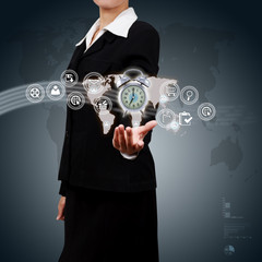 Business woman showing alarm clock and icon web symbol on hand