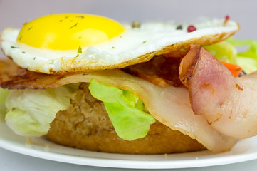 Burger with fried eggs and bacon