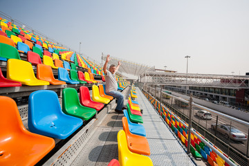Man with hands up in the seats for spectators