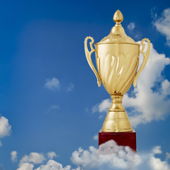 Fototapeta na wymiar Golden cup against a blue sky