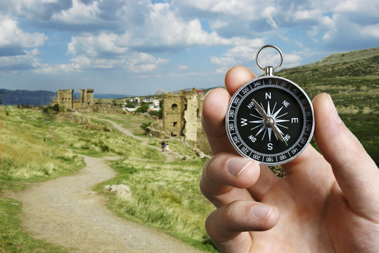 Man using a compass while sightseeing abroad