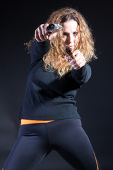 Curly sexy woman killer with handguns