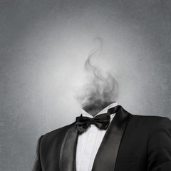 Overworked burnout business man standing headless with smoke ins