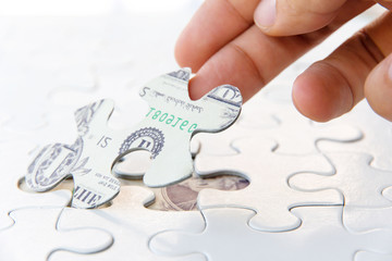 hand holding a puzzle piece, Finance concept