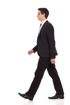 Walking businessman in black suit.