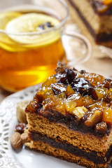 Delicious layer gingerbread cake decorated with dried fruits