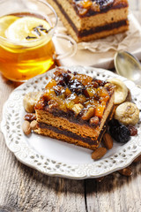 Delicious layer gingerbread cake decorated with dried fruits