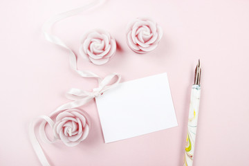 Paper card decorated with pink bow, vintage pen and roses