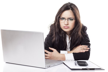 nervous and sad young business woman at the desk with a laptop