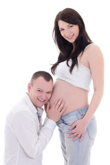 Portrait of a man listening the belly of his pregnant wife