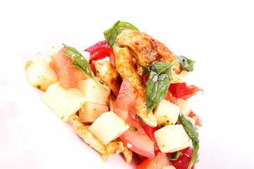 Chicken, cheese & vegetable salad with some bread on a plat